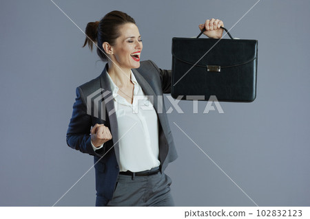 happy stylish 40 years old woman employee against gray happy stylish 40 years old woman employee against gray 102832123