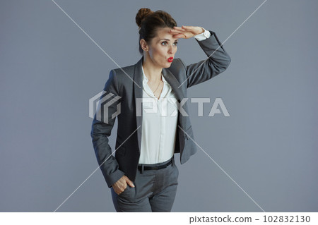 surprised business woman isolated on grey 102832130