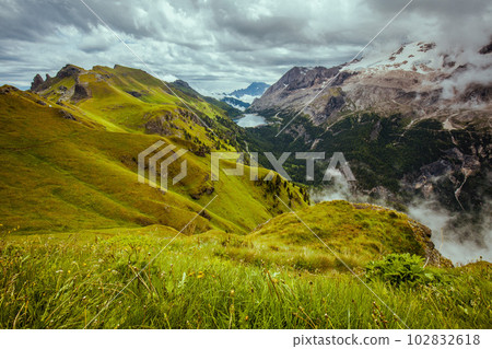 landscape with mountains, hills, clouds, grass and trees landscape with mountains, hills, clouds, grass and trees 102832618