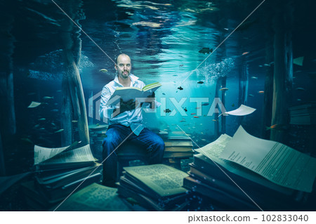man reads a book underwater 102833040