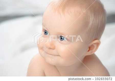 Cute baby with blue eyes - closeup portrait. Little boy looking away. Cute baby with blue eyes - closeup portrait. Little boy looking away. 102833072
