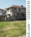 A swing in a simple park in a residential area 102833336