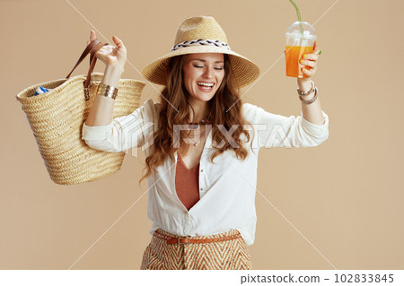 happy stylish housewife in blouse and shorts isolated on beige happy stylish housewife in blouse and shorts isolated on beige 102833845