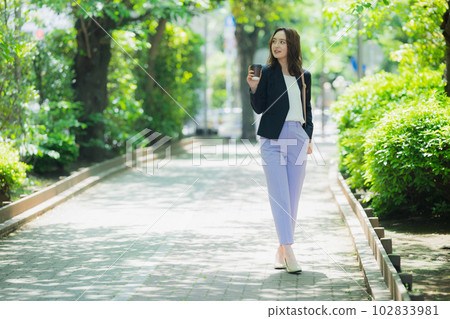 A woman walking outdoors 102833981