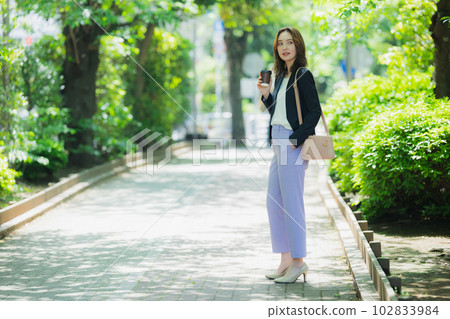 A woman walking outdoors 102833984