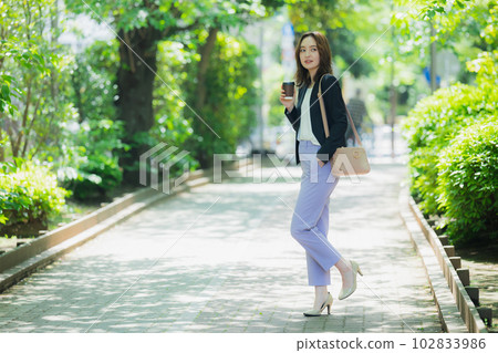 A woman walking outdoors 102833986