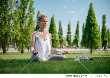 Yoga practice and meditation outdoor. Girl in the park Yoga practice and meditation outdoor. Girl in the park 102834147