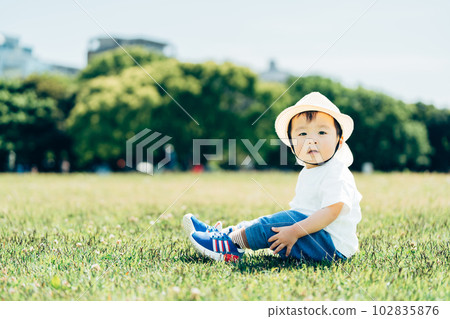 A boy sitting in the park. A boy sitting in the park. 102835876