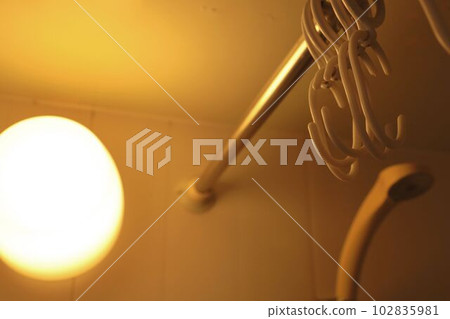 The interior of an apartment unit bath illuminated by orange lights The interior of an apartment unit bath illuminated by orange lights 102835981