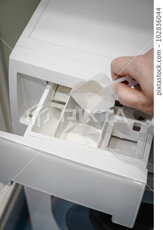 hand pouring detergent powder 102836044