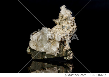 Macro mineral stone Pyrite in quartz on a black background 102836634