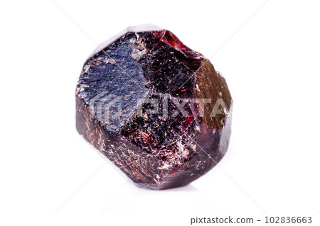 Macro of a mineral garnet stone on a white background Macro of a mineral garnet stone on a white background 102836663