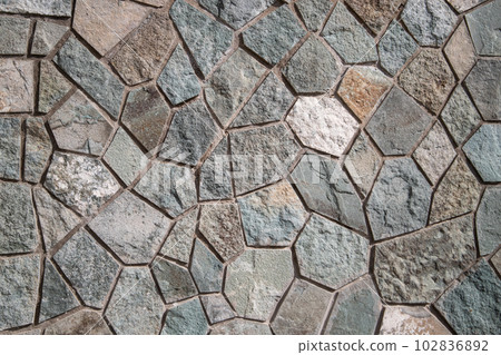 Outdoor wall neatly trimmed with flagstone background 102836892
