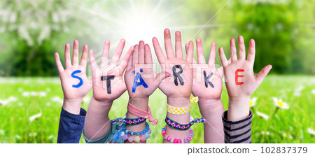 Children Hands Building Word Staerke Means Strength, Grass Meadow 102837379