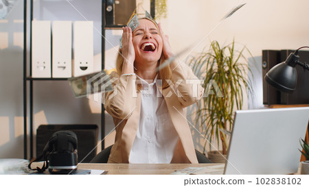 Money cash dollar rain falling on adult office businesswoman celebrating success winning career grow 102838102