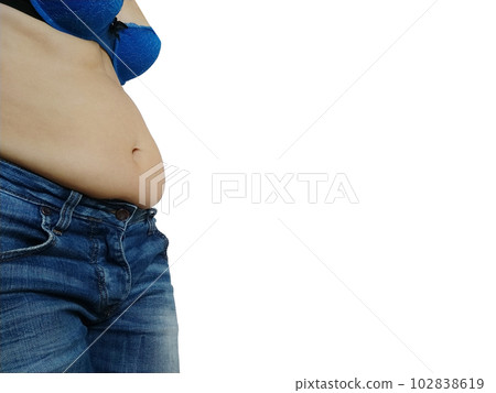 Saggy belly. Folds of leather and fat on the sides hanging over the waist of the jeans. A figure spoiled by overeating or pregnancy. Obesity and Diabetes. White background. Cellulite flabby muscles Saggy belly. Folds of leather and fat on the sides hanging over the waist of the jeans. A figure spoiled by overeating or pregnancy. Obesity and Diabetes. White background. Cellulite flabby muscles 102838619