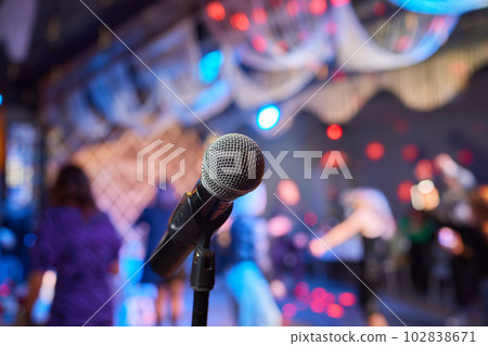 Retro microphone on stage in a pub or American Bar restaurant during a night show. Retro microphone on stage in a pub or American Bar restaurant during a night show. 102838671