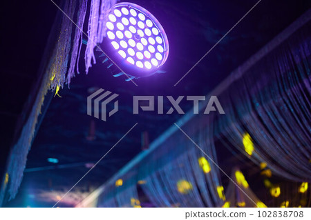 Installation of professional sound, light, video and stage equipment for a concert. Stage lighting equipment is clamped on a truss for lifting. Flight cases with cables. Installation of professional sound, light, video and stage equipment for a concert. Stage lighting equipment is clamped on a truss for lifting. Flight cases with cables. 102838708