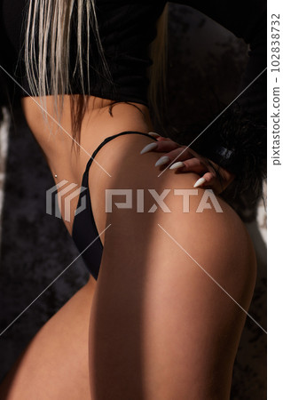 Slender narrow waist.Close up strong abdominal muscles of a young sporty woman. 102838732