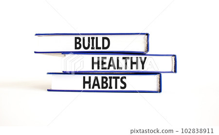 Motivation and Build healthy habits symbol. Concept words Build healthy habits on books on a beautiful white table white background. Business build healthy habits concept. Copy space. Motivation and Build healthy habits symbol. Concept words Build healthy habits on books on a beautiful white table white background. Business build healthy habits concept. Copy space. 102838911