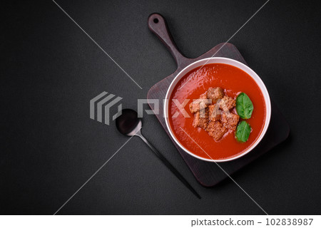 Delicious fresh gazpacho with breadcrumbs, salt and spices in a ceramic plate Delicious fresh gazpacho with breadcrumbs, salt and spices in a ceramic plate 102838987