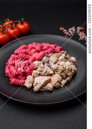 Delicious fusilli pasta with beetroot pesto, parmesan, salt and spices Delicious fusilli pasta with beetroot pesto, parmesan, salt and spices 102839058