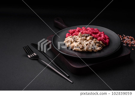 Delicious fusilli pasta with beetroot pesto, parmesan, salt and spices Delicious fusilli pasta with beetroot pesto, parmesan, salt and spices 102839059