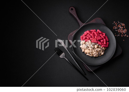 Delicious fusilli pasta with beetroot pesto, parmesan, salt and spices 102839060