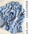 Light blue satin blouse with frills 102839806