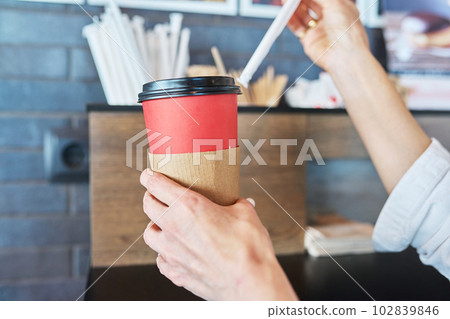 Close up hand with paper cup of coffee 102839846