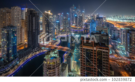 Panorama showing various skyscrapers in tallest recidential block in Dubai Marina aerial night timelapse 102839872