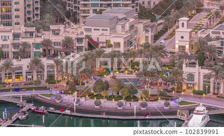 Picturesque fountain on Dubai Marina promenade aerial day to night timelapse 102839991