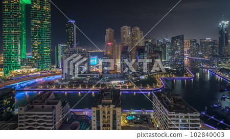 Panorama showing Dubai Marina skyscrapers and JBR district with luxury buildings and resorts aerial night timelapse Panorama showing Dubai Marina skyscrapers and JBR district with luxury buildings and resorts aerial night timelapse 102840003