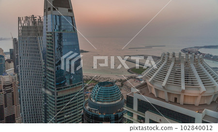 Aerial sunset view of JBR and Dubai Marina skyscrapers and luxury buildings timelapse from above 102840012