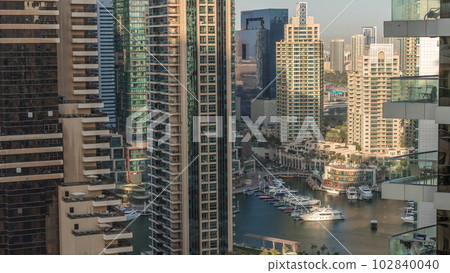 Aerial view on Dubai Marina skyscrapers and the most luxury yacht in harbor timelapse, Dubai, United Arab Emirates 102840040