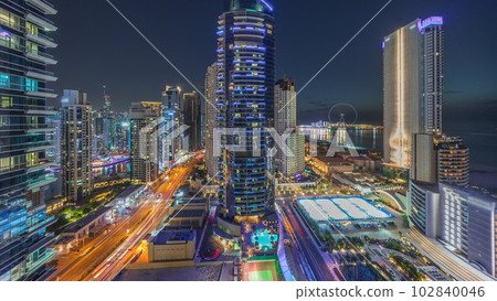 Panoramic view of the Dubai Marina and JBR area and the famous Ferris Wheel aerial day to night timelapse Panoramic view of the Dubai Marina and JBR area and the famous Ferris Wheel aerial day to night timelapse 102840046