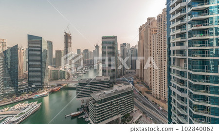 Panorama showing overview to JBR and Dubai Marina skyline with modern high rise skyscrapers waterfront living apartments aerial timelapse 102840062