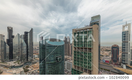 Panorama showing Dubai international financial center skyscrapers with promenade on a gate avenue aerial timelapse. Panorama showing Dubai international financial center skyscrapers with promenade on a gate avenue aerial timelapse. 102840099