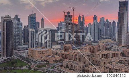 Dubai's business bay towers at sunset aerial timelapse. Rooftop view of some skyscrapers 102840132
