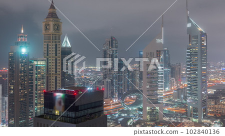 Skyscrapers on Sheikh Zayed Road and DIFC day to night timelapse in Dubai, UAE. 102840136