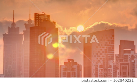 Dubai skyscrapers with golden sunset over business bay district timelapse. Dubai skyscrapers with golden sunset over business bay district timelapse. 102840221