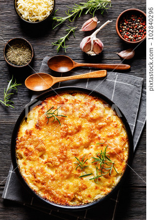 cheesy potato bake or potato casserole, top view 102840296