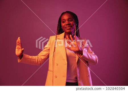 Woman african american business smile dancing party in neon light, colorful pink color, bright coloring. Woman african american business smile dancing party in neon light, colorful pink color, bright coloring. 102840304