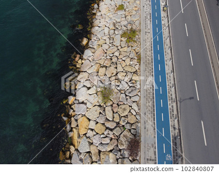 Large granite stones on the river bank. The edge of the river bank, water, road 102840807