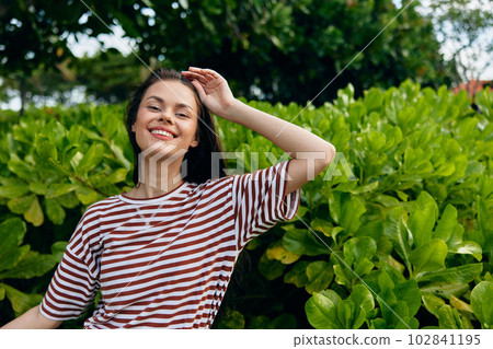 woman smiling summer lifestyle t-shirt freedom nature walk hipster beautiful park 102841195