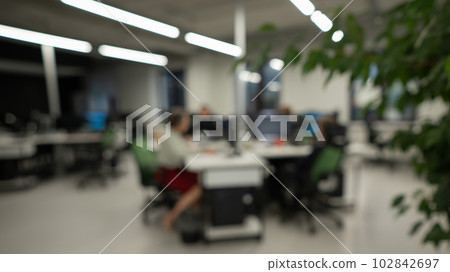 Blurry photo. Four colleagues at their desks. Blurry photo. Four colleagues at their desks. 102842697