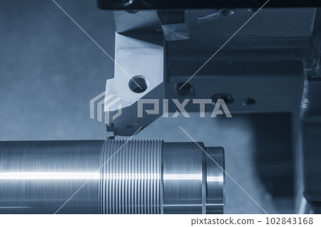 Close up scene the CNC lathe machine thread cutting at the end of metal shaft parts. Close up scene the CNC lathe machine thread cutting at the end of metal shaft parts. 102843168