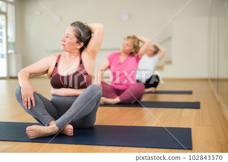 Ladies are sitting in a lotus pose Ladies are sitting in a lotus pose 102843370