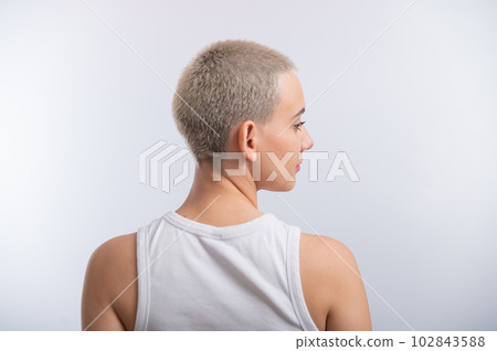 Pretty young woman with a short blond haircut on a white background. Pretty young woman with a short blond haircut on a white background. 102843588