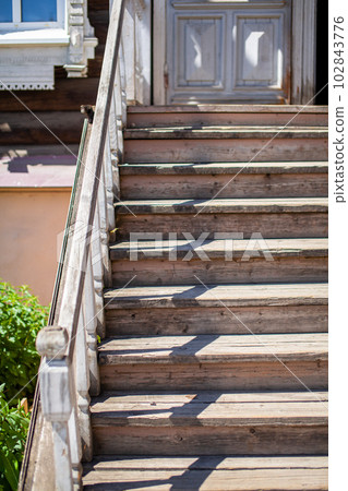 Old wooden two-storey houses with windows in the city of Tomsk Old wooden two-storey houses with windows in the city of Tomsk 102843776